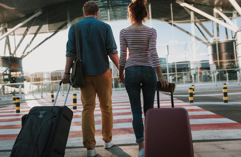 man en vrouw met bagage buiten aan de luchthaven